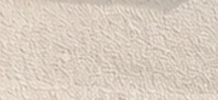 Close-up of a textured monocouche render finish